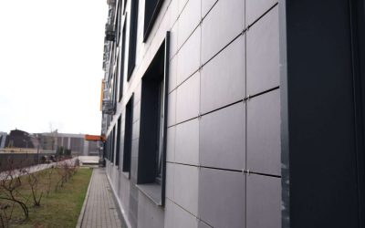 wall of office building made of metal plates with windows. Detail of modern residential building windows on ceramic ventilated facade