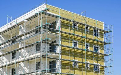 Thermal insulation of the facade of a apartment building with mineral wool plates using scaffolding around facade