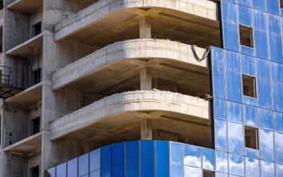 Installation double glazed windows on high-rise building. Building construction, glazing facade of new building. Mount insulated glass panels on facade of high-rise building