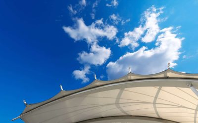 Tensile membrane fabric roof on blue sky with clouds