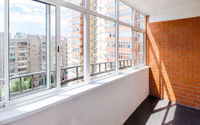 Glazed balcony with brick wall