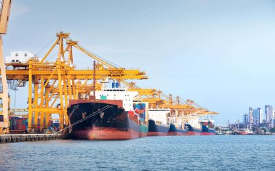 Large crane and cargo ship transport cargo container and docked at port in Bangkok of Thailand. Business industry of shipping, logistics, international global trade, freight transport, import export.
